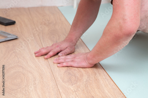 Laminate. Installing laminate at home on a plywood floor.