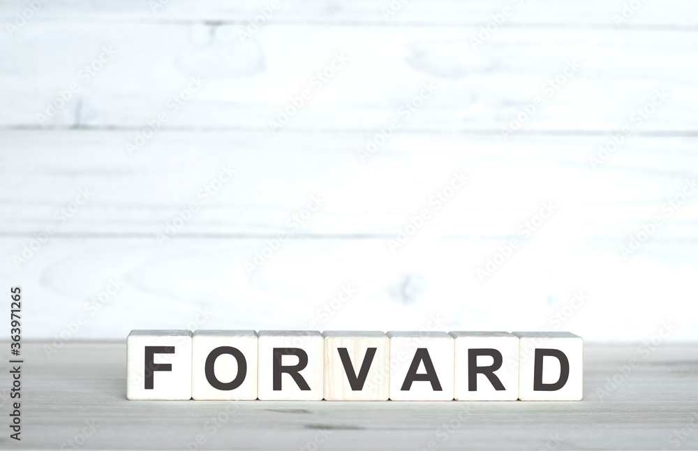 Forward. Motivation Concept. The inscription on wooden cubes on a wooden background Forward. Motivation Concept. The inscription on wooden cubes on a wooden background