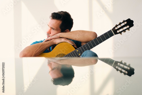 Musician With Guitar Feeling Uninspired And Lacking Creativity photo