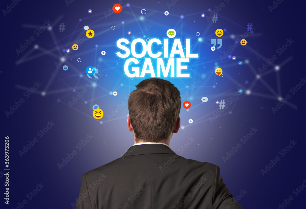 Rear view of a businessman with SOCIAL GAME inscription, social networking concept Rear view of a businessman with SOCIAL GAME inscription, social networking concept