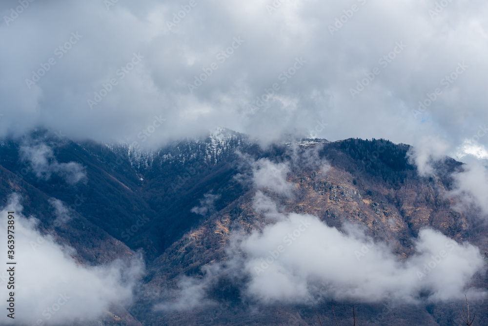 Mountain with snow and puffy clouds in Switzerland