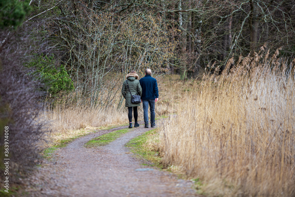 Man and woman walking in a nature reserve Man and woman walking in a nature reserve