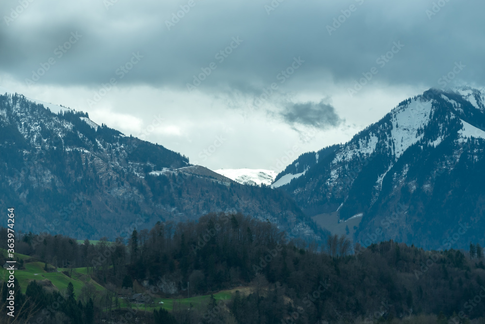 Mountain with snow and dark moody clouds in Switzerland