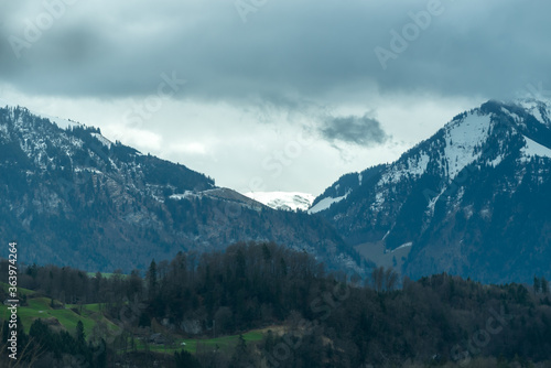 Mountain with snow and dark moody clouds in Switzerland