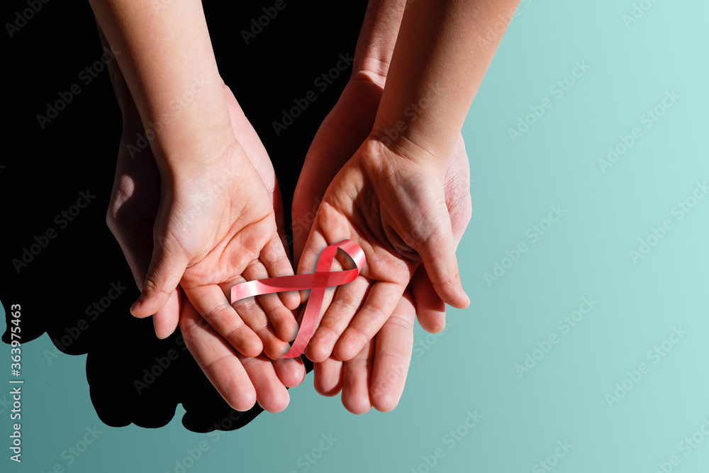 red aids ribbon in hand. red aids ribbon in hand.