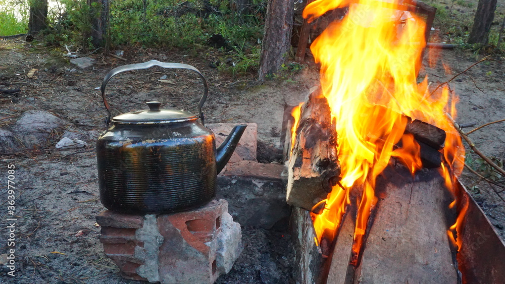 outdoor recreation black metal teapot on the fire flame fire outdoor recreation black metal teapot on the fire flame fire