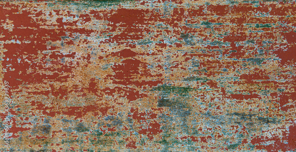 Red green old peeling textured wall.
