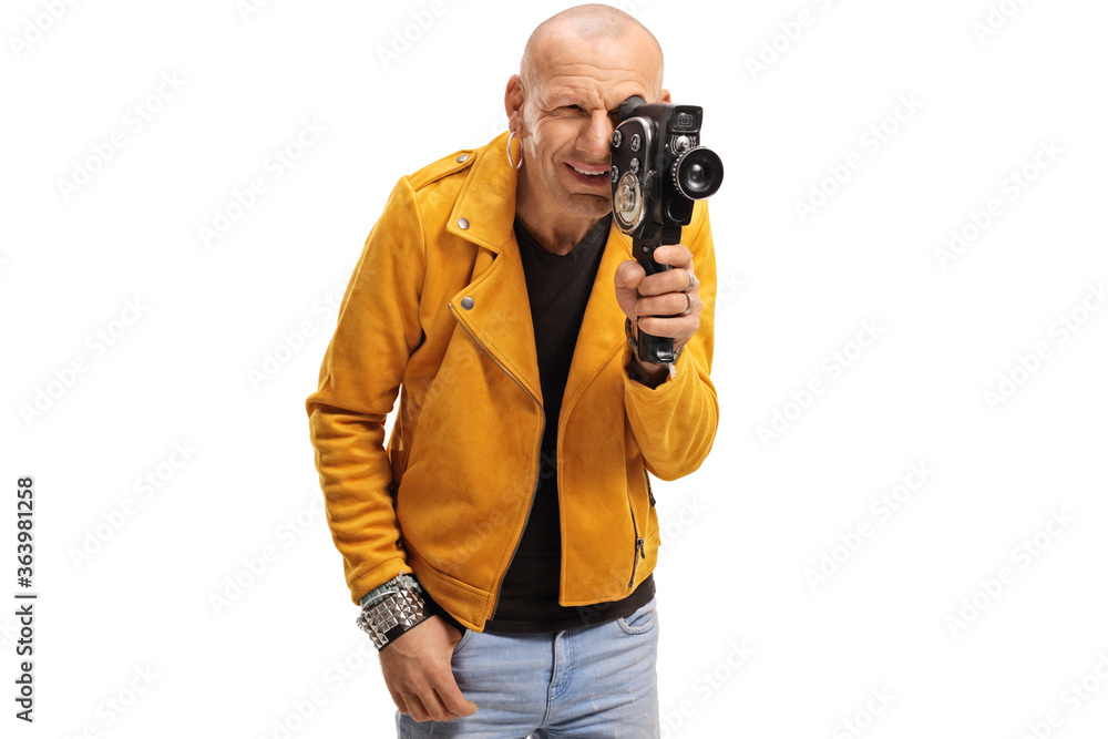 Bald hipster guy filming with a vitnage camera recorder Bald hipster guy filming with a vitnage camera recorder