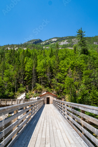 Young woman sitting at the summit of the "Mont-du-lac-des-cygnes" in Charlevoix, Quebec