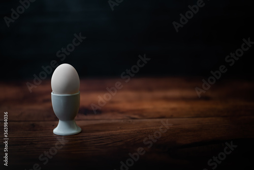 Egg in egg cup on a wooden table