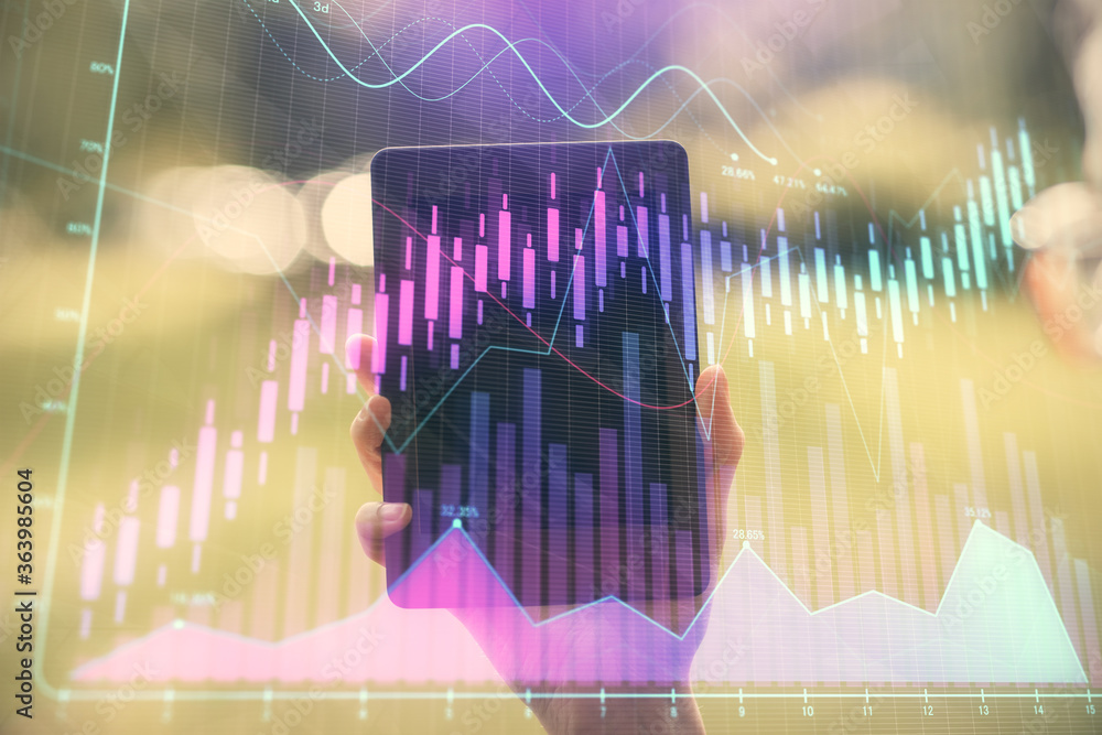 Double exposure of forex chart sketch hologram and woman holding and using a mobile device. Financial market concept. Double exposure of forex chart sketch hologram and woman holding and using a mobile device. Financial market concept.
