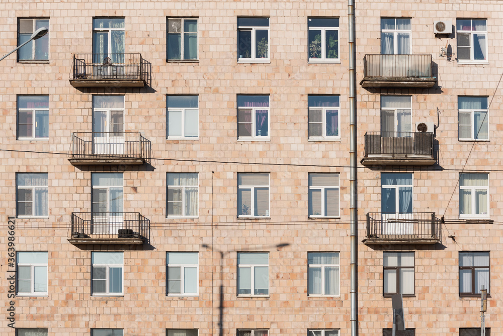 Old residential building exterior, full frame. Soviet multistorey house of Khrushchev time in St. Petersburg, Russia. Old residential building exterior, full frame. Soviet multistorey house of Khrushchev time in St. Petersburg, Russia.