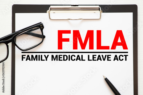 Paper with Family Medical Leave Act FMLA on a table photo