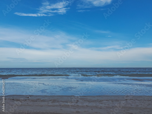 Fototapeta Naklejka Na Ścianę i Meble -  Seagull on the beach. Sand background of free space for your decoration. Soft Wave Of Blue Ocean On Sandy Beach, Summer time. Rockaway Beach, New York. Quiet and peaceful place