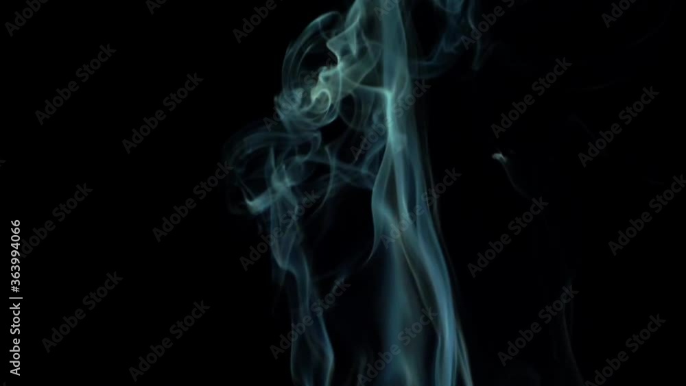 Closeup of a ray of abstract blue smoke rising on black background, mist design Closeup of a ray of abstract blue smoke rising on black background, mist design