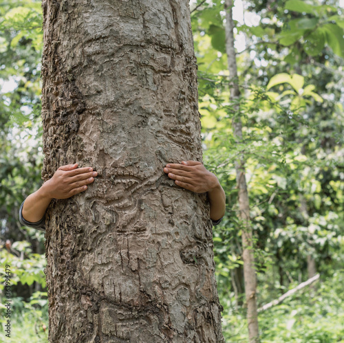 man hugging a big tree, concept for natural preserve, earth day , sustainable lifestyle