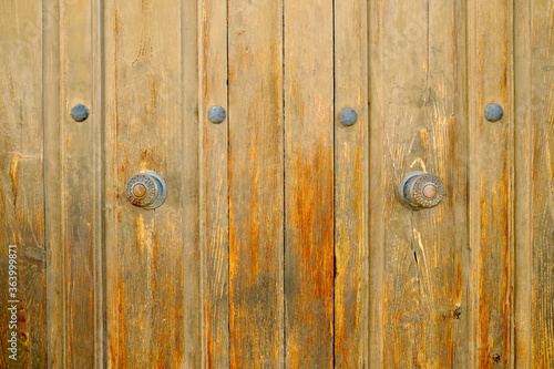 Very old church doors. Wooden panels and door knobs in a 19th century church, Europe..