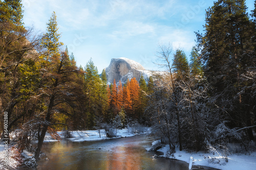 Beautiful View of Mountains in the river with trees and snow covered mountains © Ernest