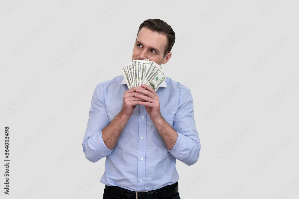 Happy businessman hiding behind bunch of money banknotes Happy businessman hiding behind bunch of money banknotes