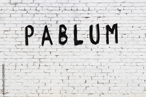 White wall with black paint inscription pablum on it