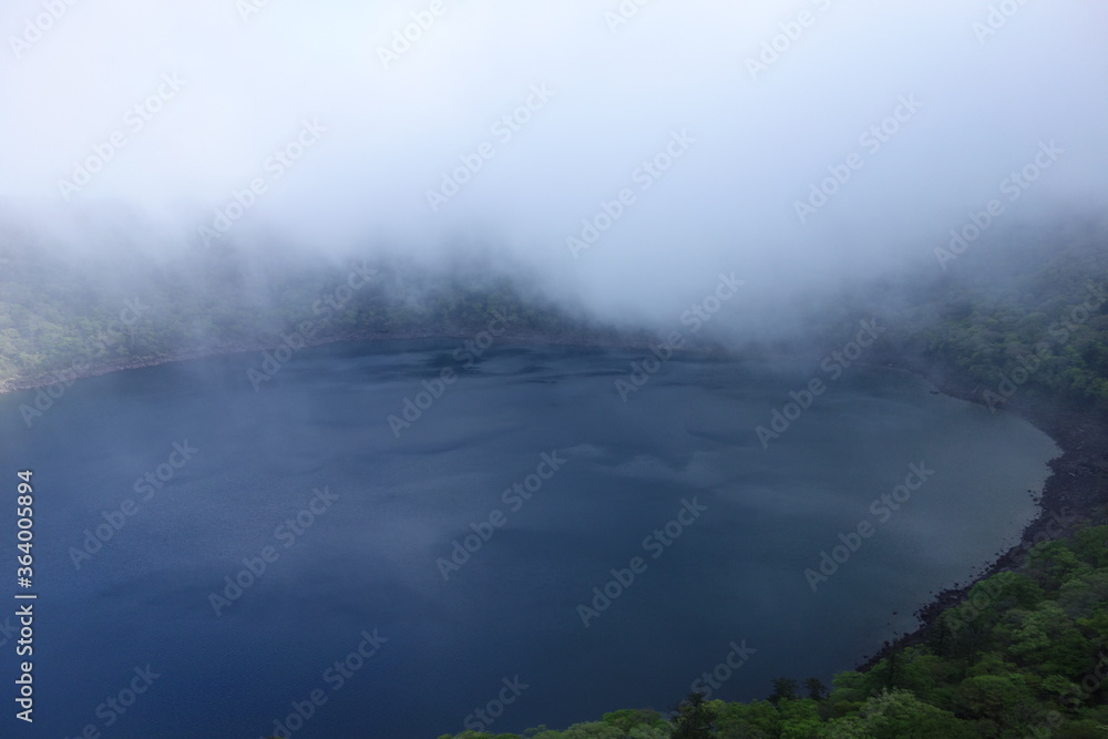 Onami-lake(old crater) covering fog in Kirishima mountain range in the early morning, Miyazaki, Japan Onami-lake(old crater) covering fog in Kirishima mountain range in the early morning, Miyazaki, Japan