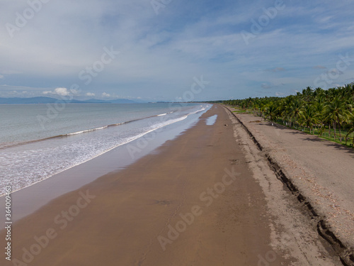 Beautiful aerial view of a empty beach due to the quarantine for Covid19  with a police car in Costa Rica 
