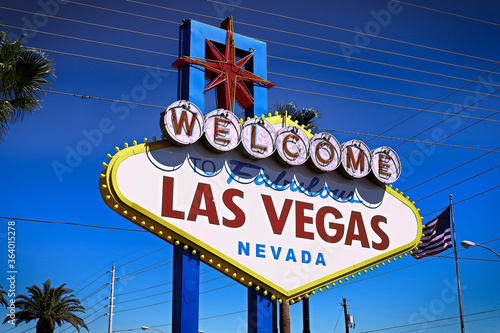 ラスベガスの観光名所 ウエルカムサイン The Welcome to Fabulous Las Vegas sign on bright sunny day in Las Vegas.Welcome to Never Sleep city Las Vegas, Nevada Sign with the heart of Las Vegas scene in the background. photo