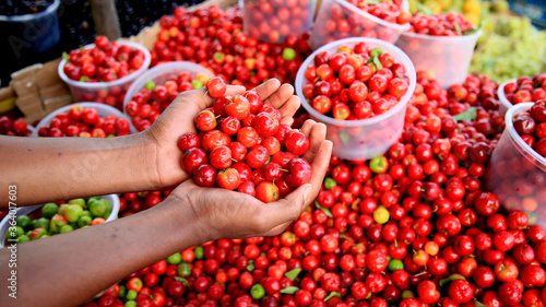 salvador, bahia / brazil - july 10, 2020: acerola fruit are seen for sale in the city of Salvador. photo