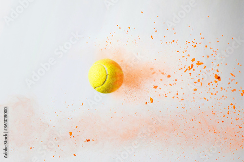 tennis ball with color powders on white background.