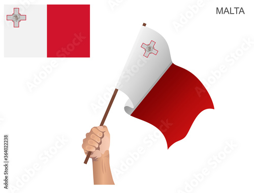  The flag of the country of Malta is hoisted with a stick held by hand to ignite the spirit of statehood