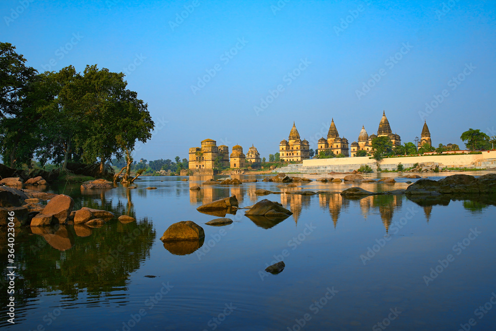 Naklejka premium View of Royal cenotaphs (Chhatris) of Orchha over Betwa river. Orchha, Madhya Pradesh, India.