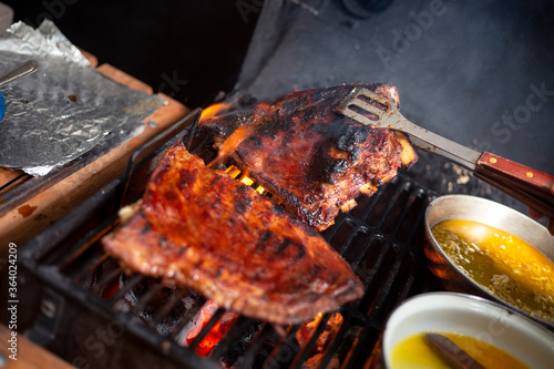 Grilled pork ribs, delicious grilled ribs, home barbecue - cooking grilled meat
