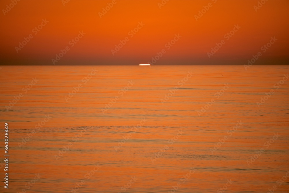 custom made wallpaper toronto digitalA cold orange sun sets on the North Sea. Fall. Cold evening. Photo from the side of the ship.