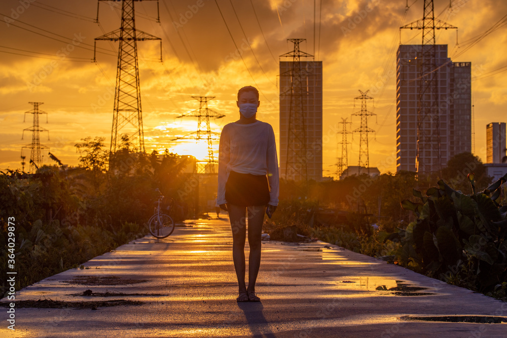 A coquettish silhouette of a woman in the sunset A coquettish silhouette of a woman in the sunset
