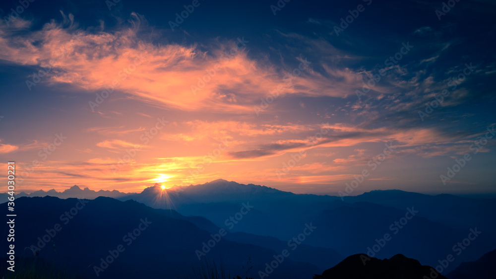 Beautiful natural panoramic landscape view of the sunrise of Himalayan snow mountains from Chandrashila peak in Chopta, Uttarakhand, India,.