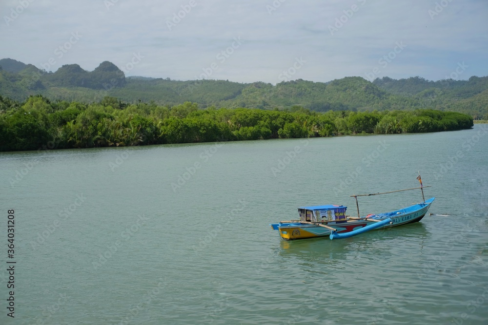 Fototapeta premium Fishing boats parked at the river mouth near Ayah Beach