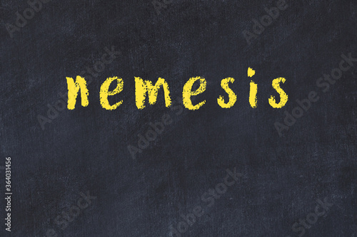 Foto College chalk desk with the word nemesis written on in