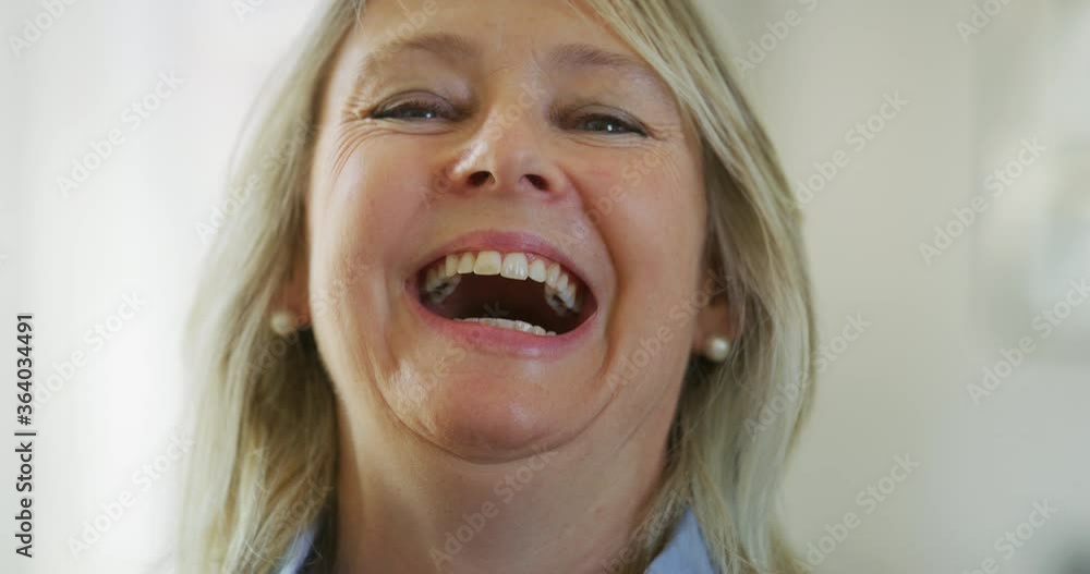 Authentic close up of an attractive mature blond hair woman with blue ...