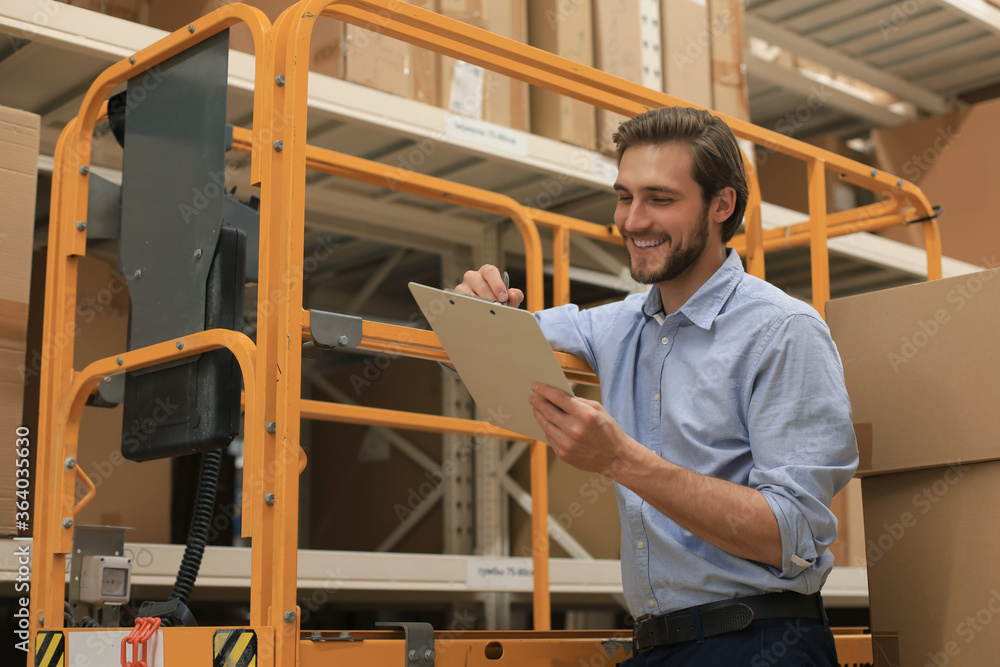 Fototapeta premium Manager use his tablet for online checking products available.