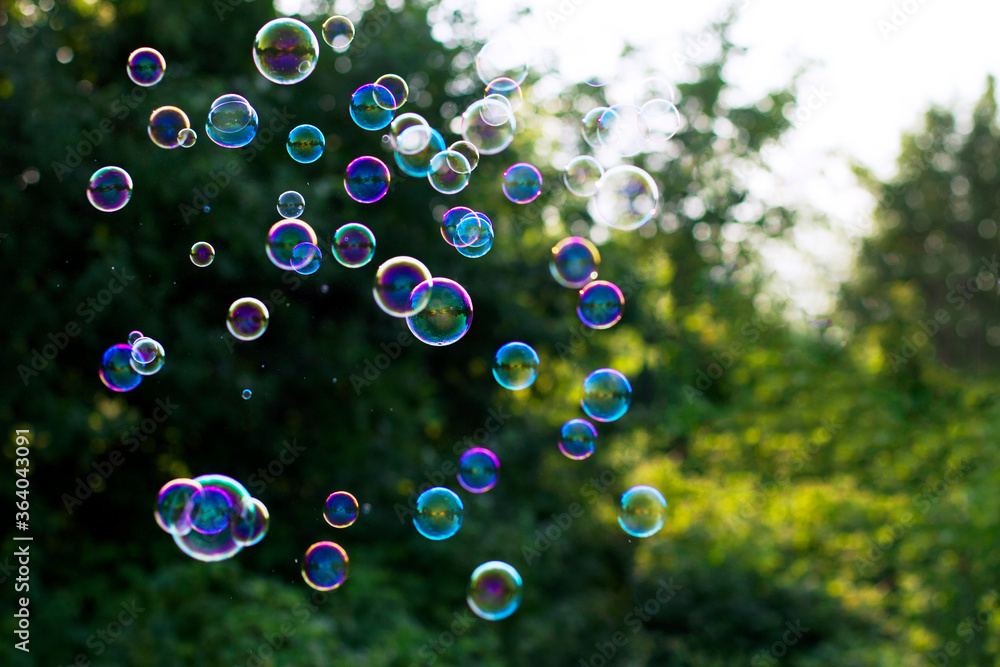 Soap bubbles on a green background. Summer background.