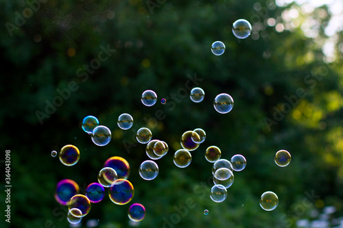 Soap bubbles on a green background. Summer background.