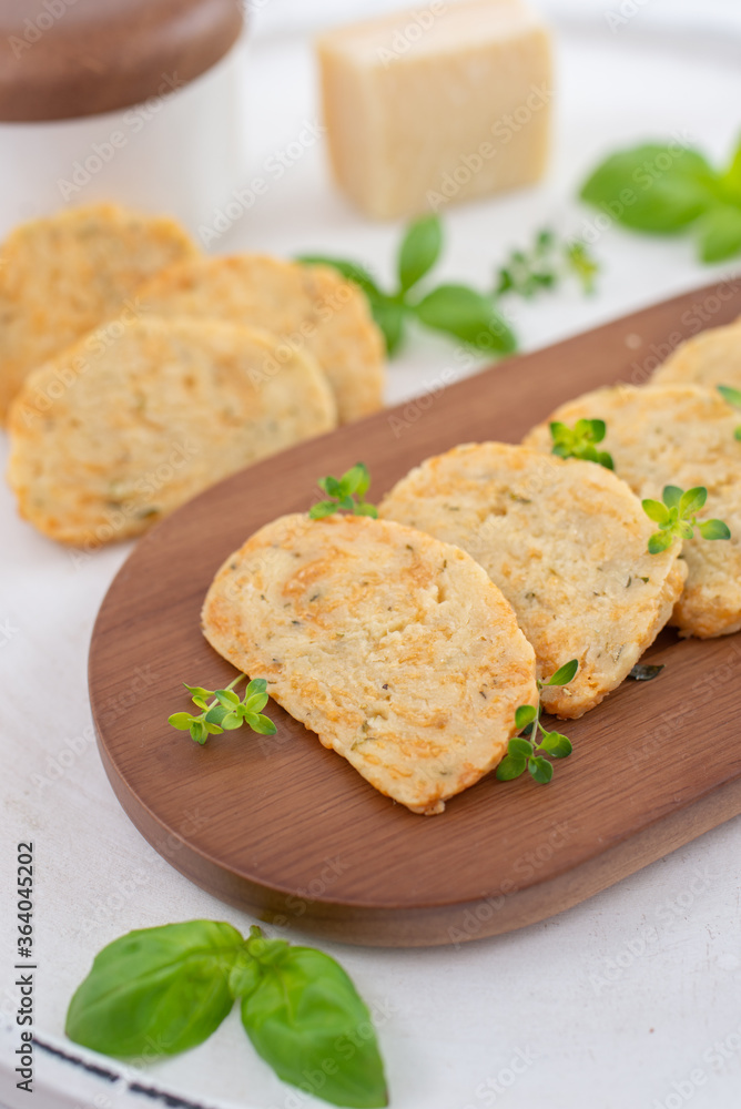 home made cheese crackers with herbs on a table home made cheese crackers with herbs on a table
