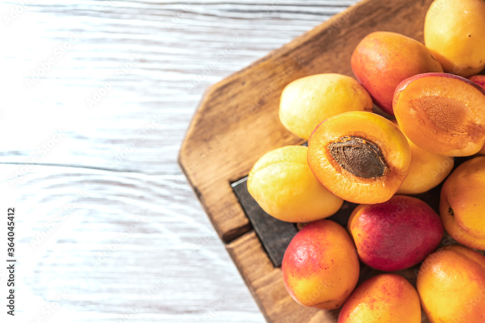 Ripe fresh apricots on a wooden background. Summer fruit concept. Rustic style. Free space for your text. Ripe fresh apricots on a wooden background. Summer fruit concept. Rustic style. Free space for your text.