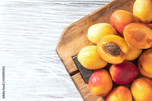 Ripe fresh apricots on a wooden background. Summer fruit concept. Rustic style. Free space for your text.