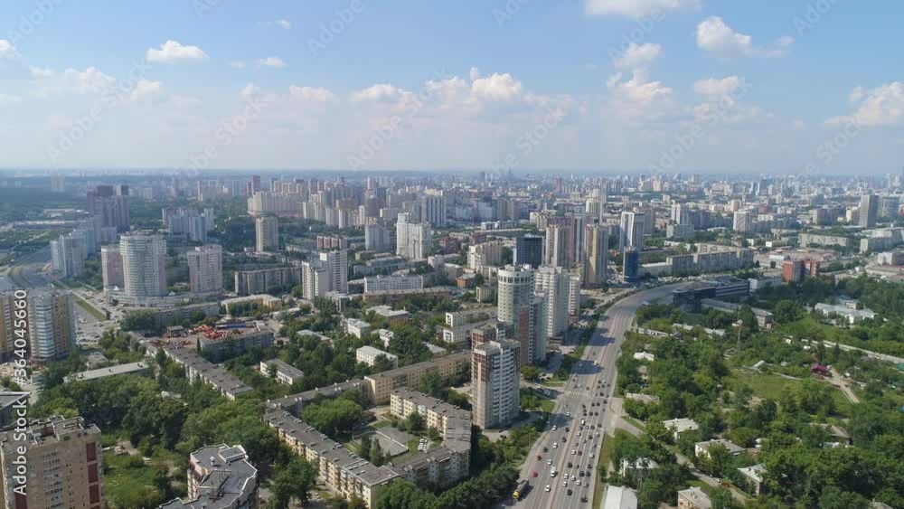 Aerial view of big city with modern high-rise buildings with car traffic. The city has a lot of greenery and trees. Summer sunny day. There are clouds in the blue sky
Aerial view of big city with modern high-rise buildings with car traffic. The city has a lot of greenery and trees. Summer sunny day. There are clouds in the blue sky