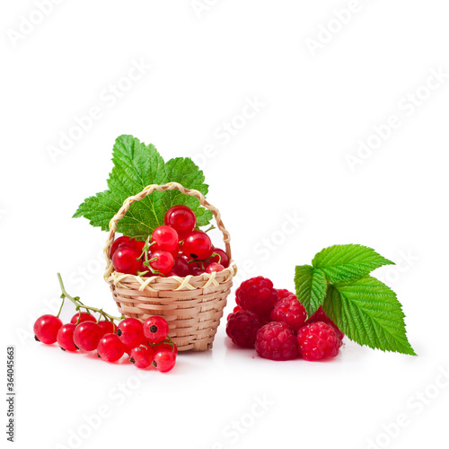 Red currant berries with raspberries in a basket isolated on a white background.