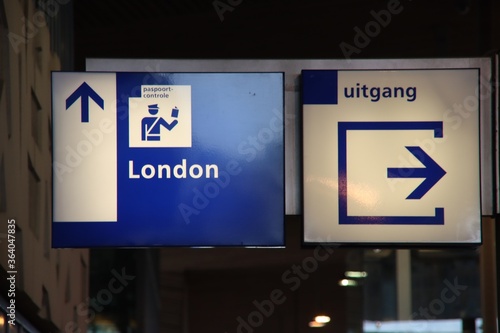 Blue and white direction sign to the passport control to london at Rotterdam station for Eurostar. photo