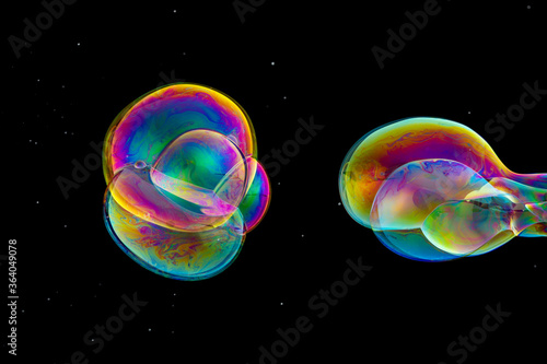 close up of various shapes soap bubble isolated on balck background