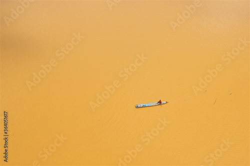 a lone boatman on the yellow river in Kota Bharu in Malaysia