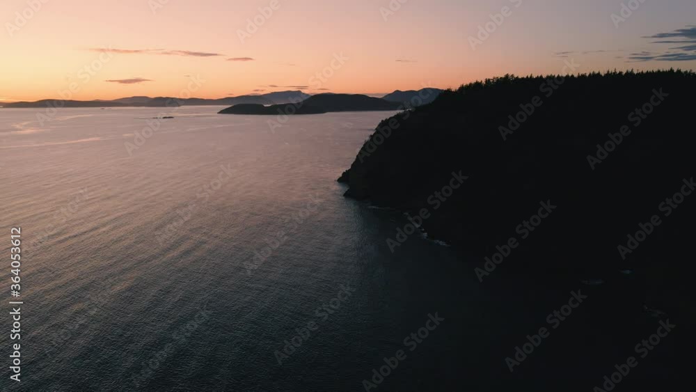 Afterglow Aerial of Rocky Ocean Island Silhouette on Puget Sound Afterglow Aerial of Rocky Ocean Island Silhouette on Puget Sound